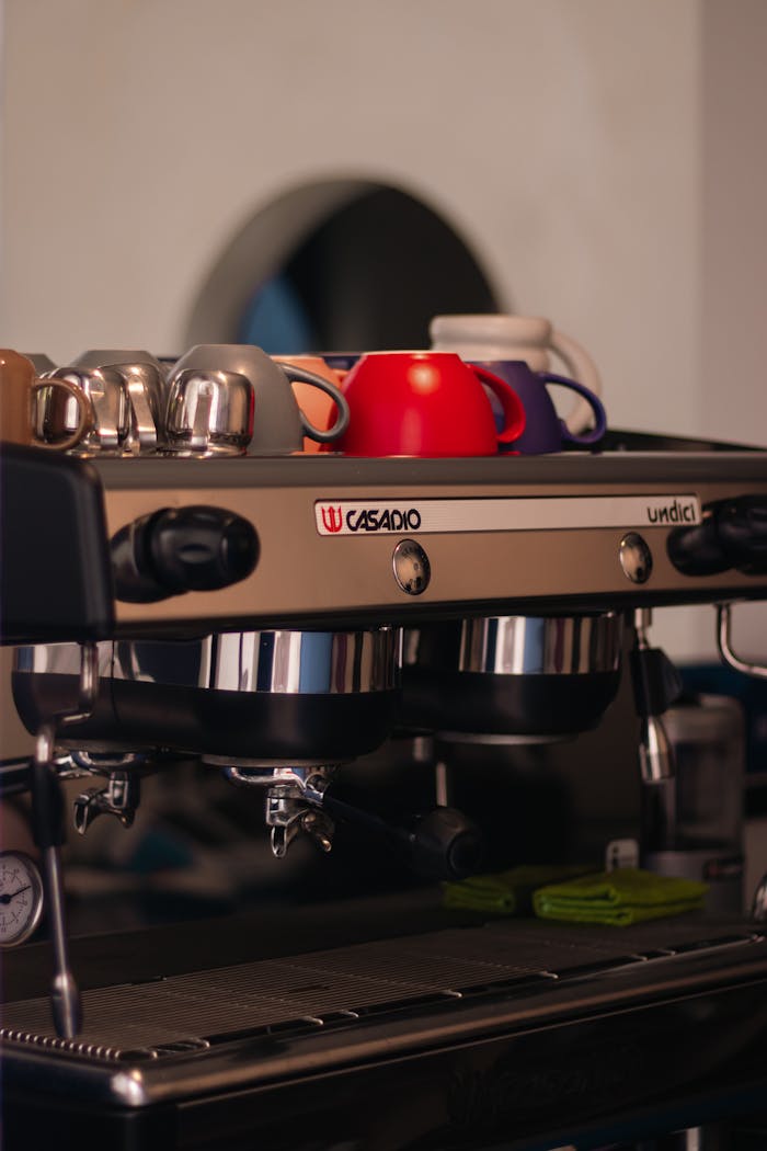 services-02 Espresso machine with colorful cups on top, ideal for coffee shop visual content.
