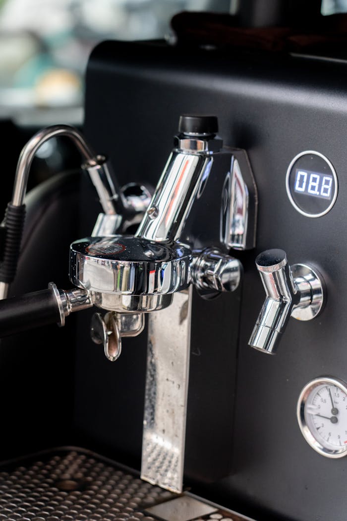 services-03 Detailed view of an espresso machine's portafilter and controls, perfect for coffee enthusiasts.